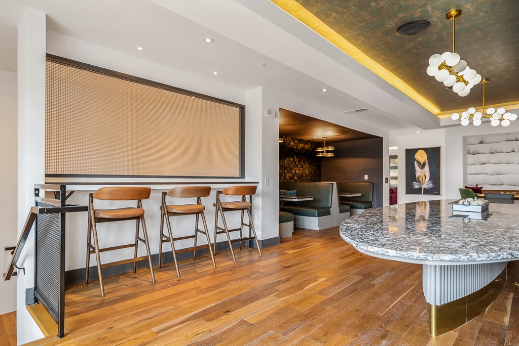 A bar area with a counter and chairs.