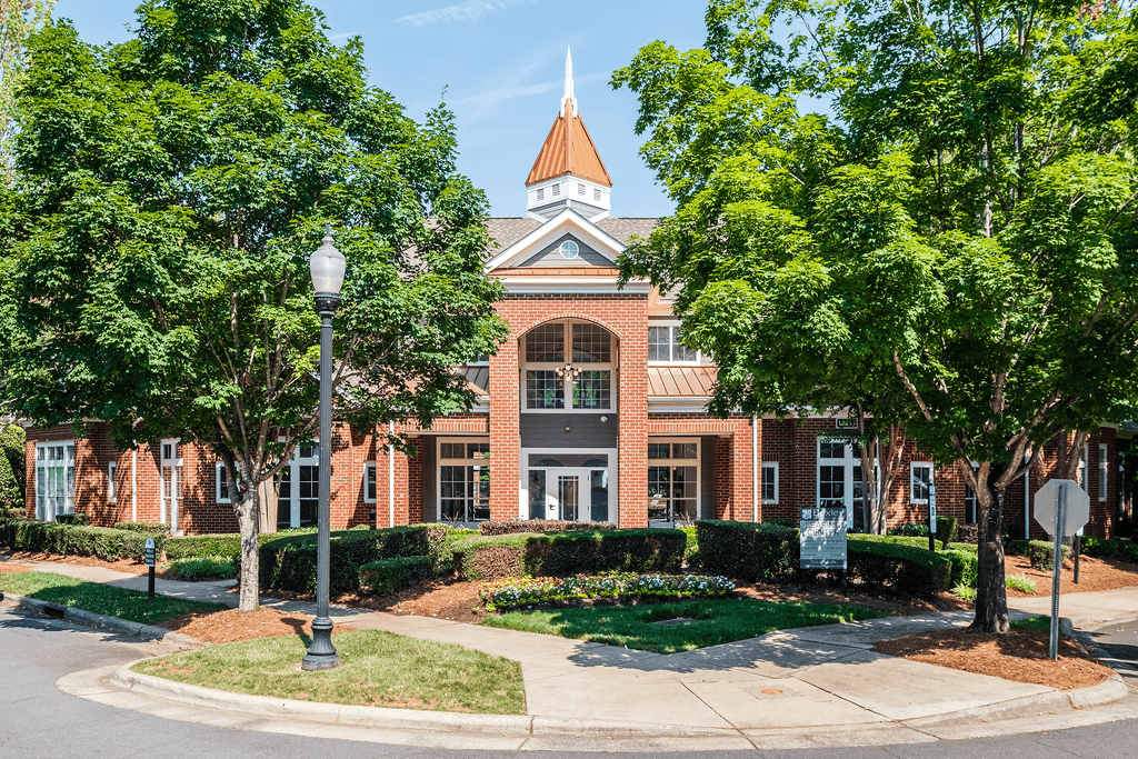 a large brick building with trees in front of it