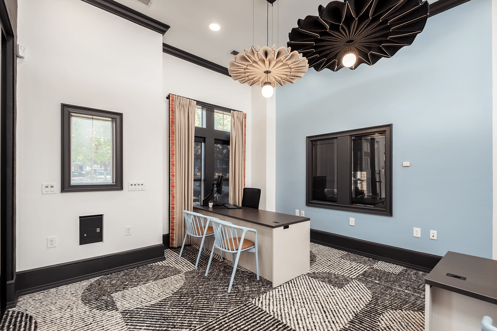 a conference room with a desk and chairs and a window