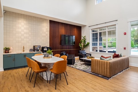 a living room and dining room with a table and chairs