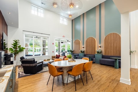 A modern dining room with a large table and chairs.