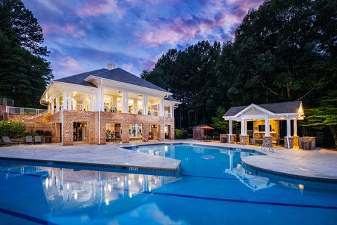 A large house with a pool in front of it.