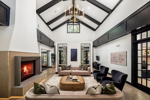 A modern living room with a fireplace and a large painting on the wall.