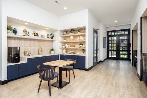 A modern kitchen with a dining table and chairs.