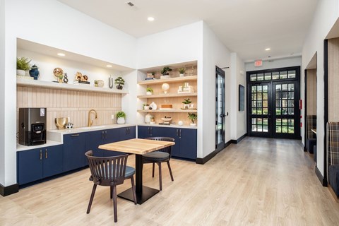 A modern kitchen with a dining table and chairs.