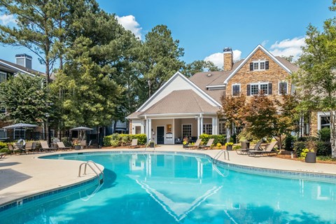 A large house with a pool in front.