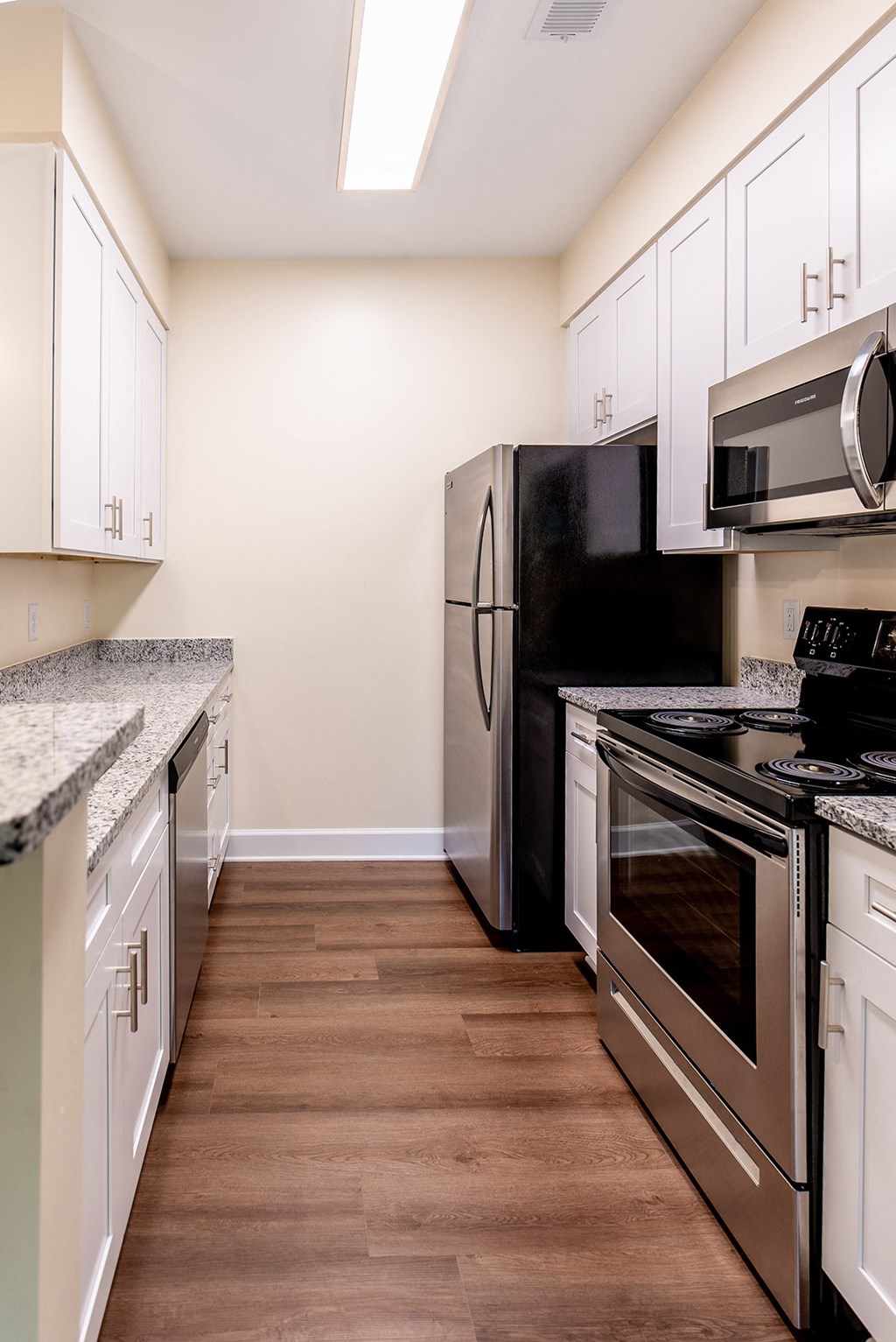 a kitchen with stainless steel appliances and white cabinets