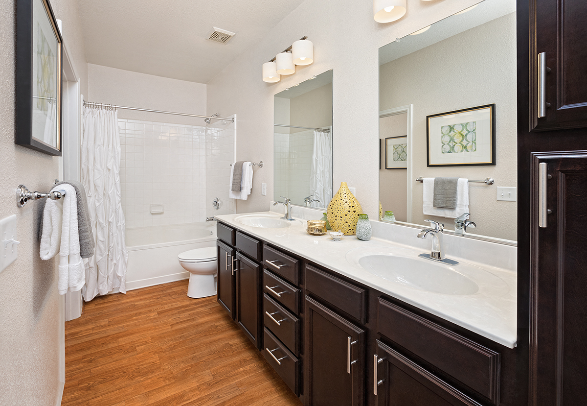 a bathroom with a sink and a toilet and a shower