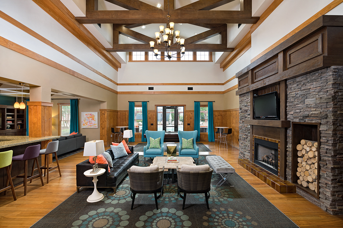 a large living room with a fireplace and couches