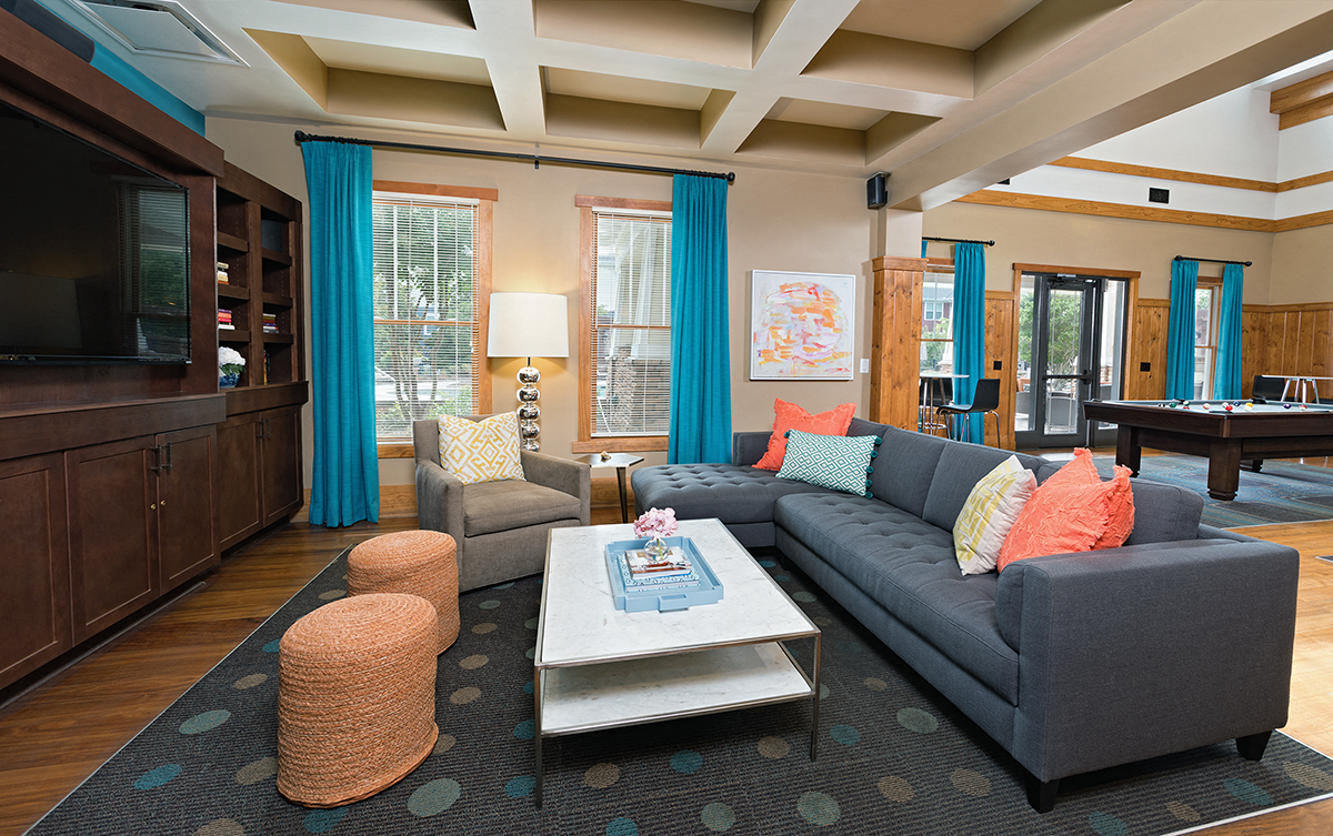a living room with a blue couch and a coffee table