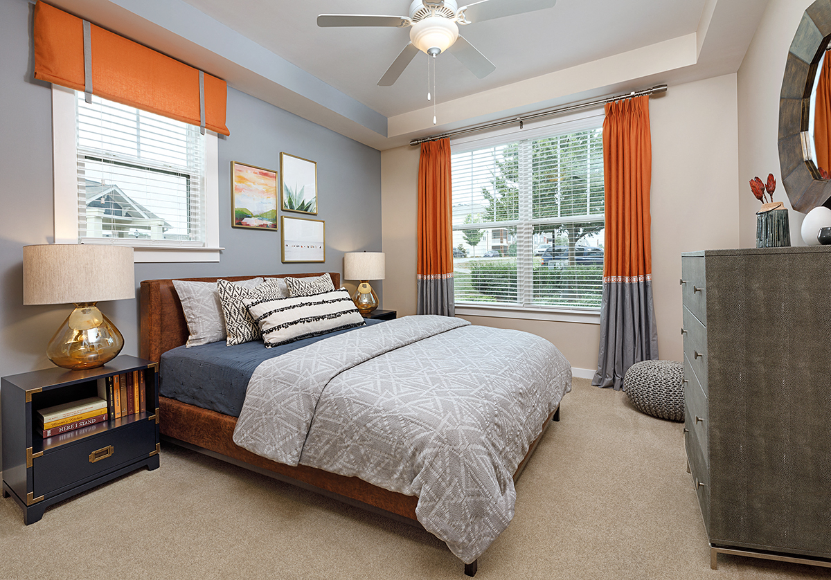 a bedroom with a bed and a ceiling fan