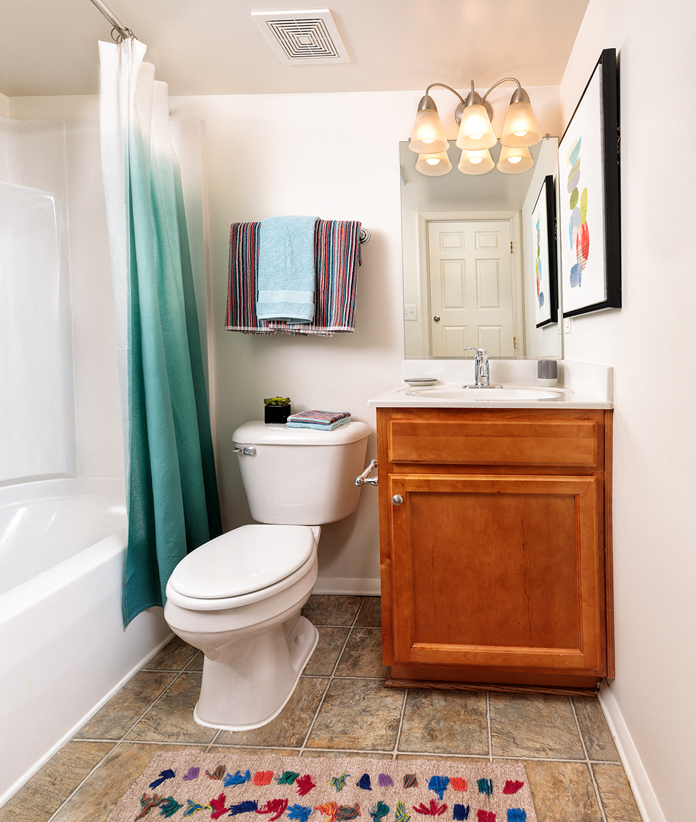 a bathroom with a toilet and a sink and a shower