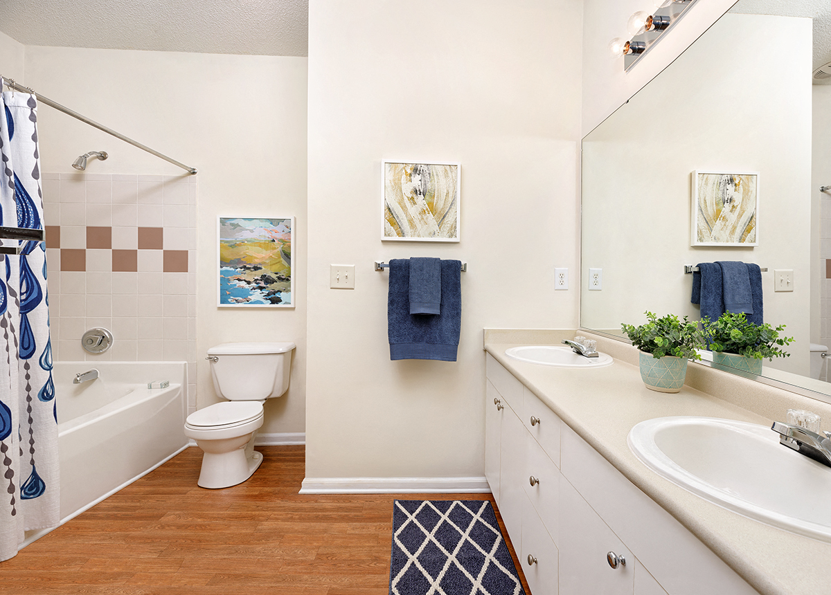 a bathroom with a toilet and a tub and a sink