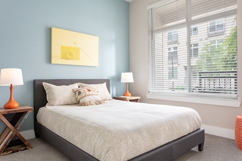 a bedroom with a bed and a large window