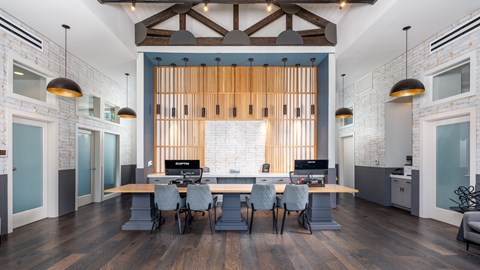 A modern office space with a long table and chairs.