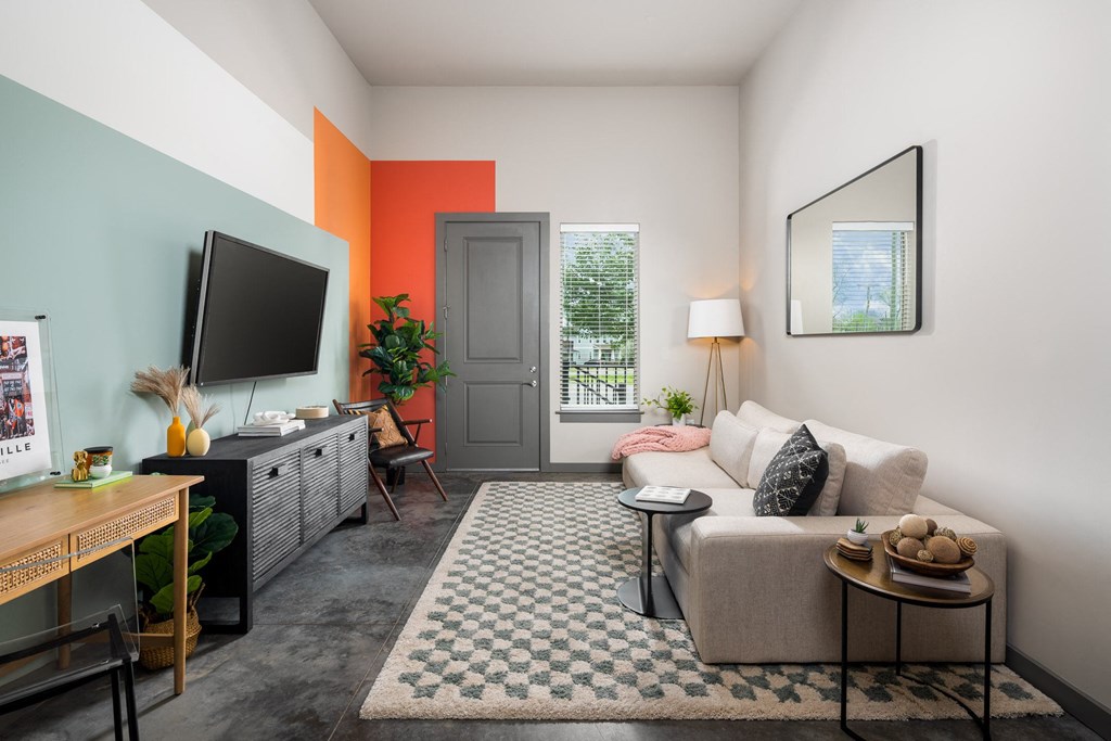 a living room with a couch and a tv on a stand