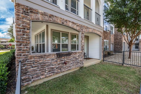 A house with a stone wall and a white garage door.