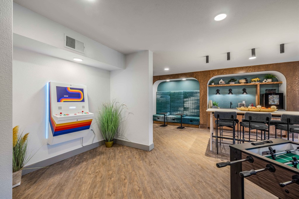 a game room with a pool table and a bar