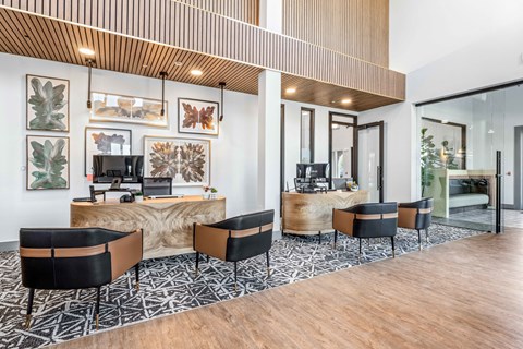 a lobby with a desk and chairs and a reception area