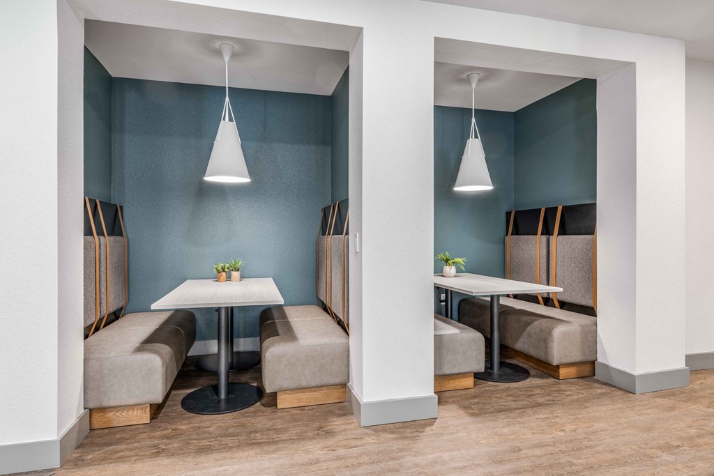 a dining room with tables and chairs and blue walls