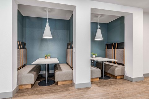 a dining room with tables and chairs and blue walls