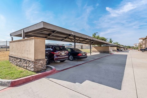 a parking garage with cars parked under it