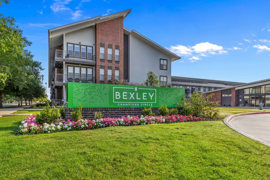 a large building with a green sign in front of it