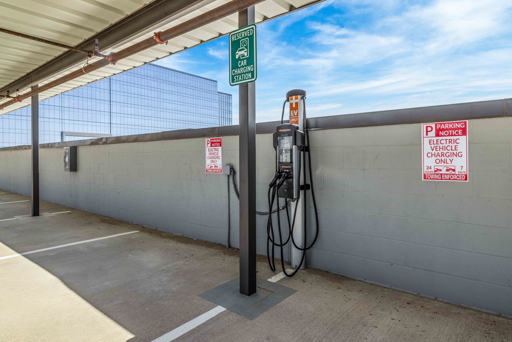 an electric vehicle charging in a parking garage