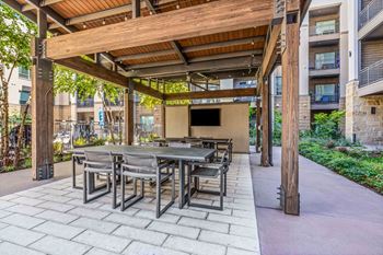 large patio with a pergola and tables and chairs