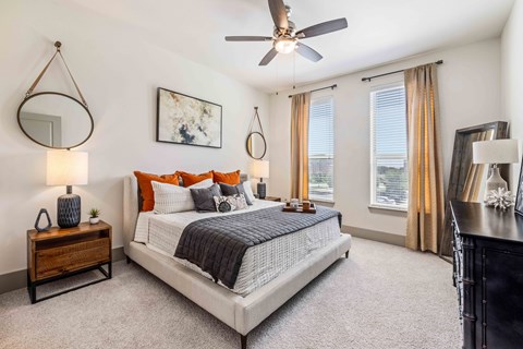 a bedroom with a bed and a ceiling fan