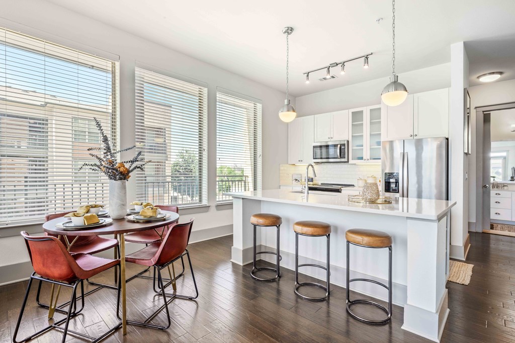 a kitchen with a large island with a breakfast bar and stools