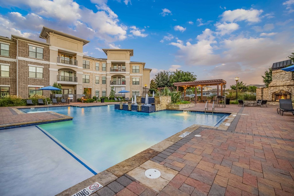 a large swimming pool with a building in the background