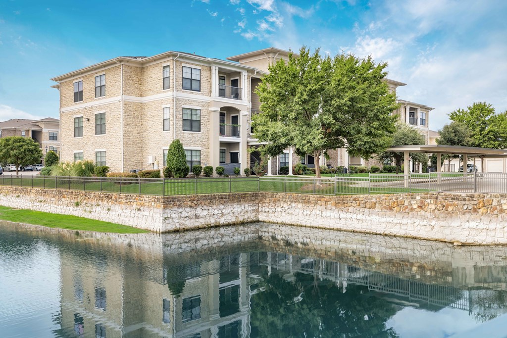the building in which the hotel is located is reflected in the water