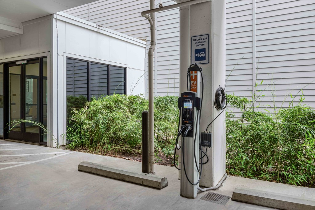 a gas station in front of a white building
