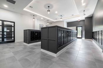 the tasting room has a wall of wine racks and a counter with bottles in it