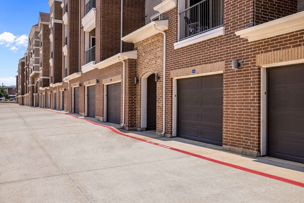 a row of garage doors on a brick building
