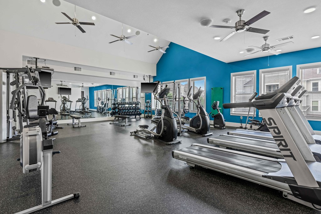 a gym with treadmills and other exercise equipment