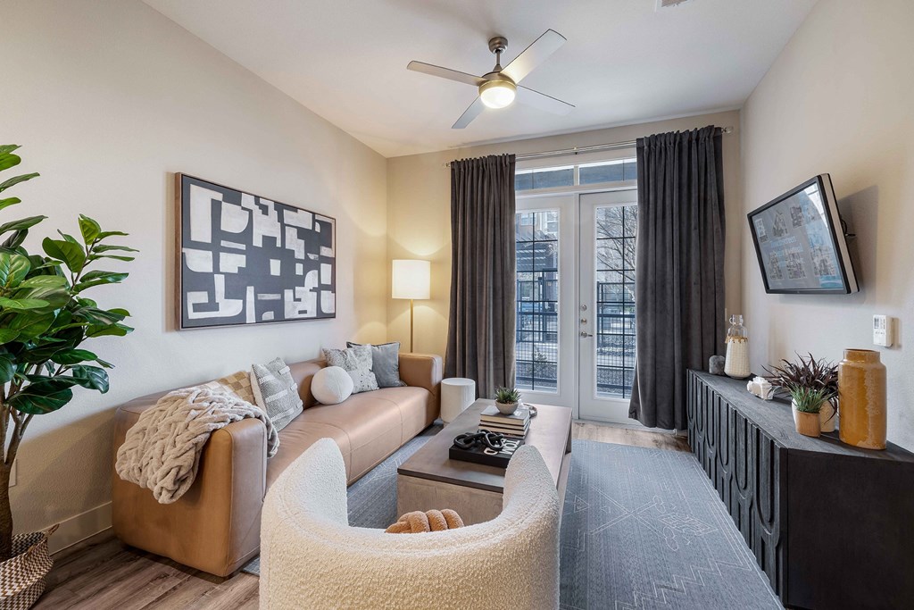 a living room with a couch and a ceiling fan