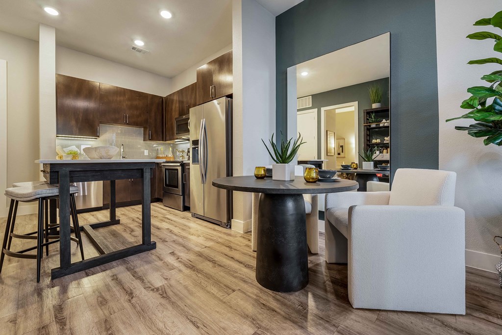 a living room with a kitchen and a dining table
