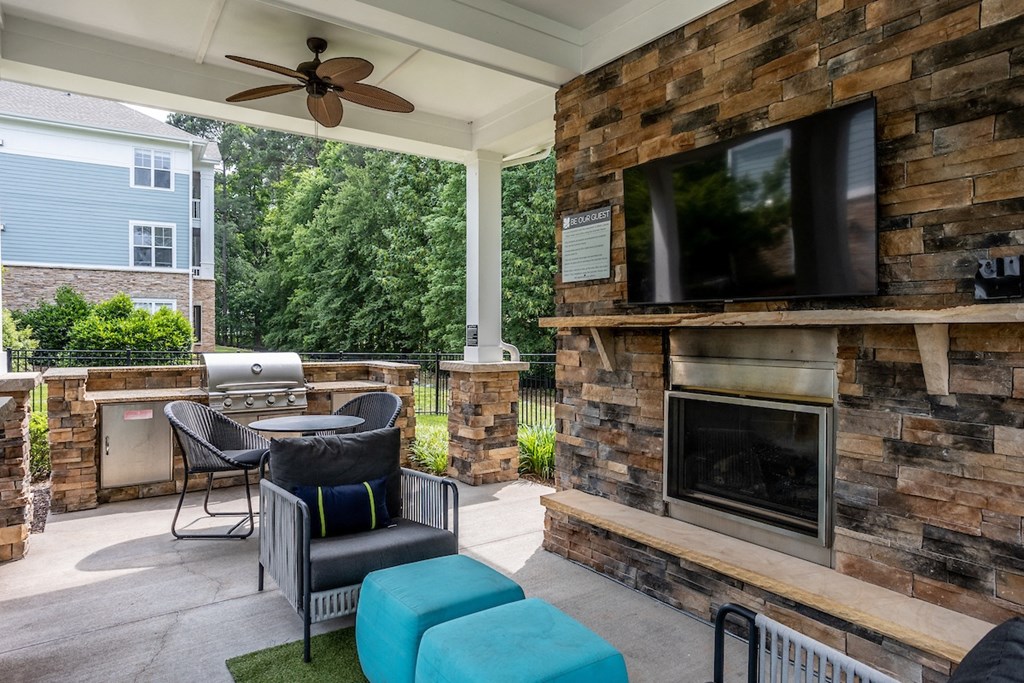 summerhouse with fireplace, seating, and tvs