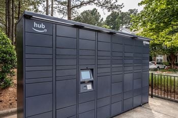 a self storage facility with a dark gray exterior and a white hub logo