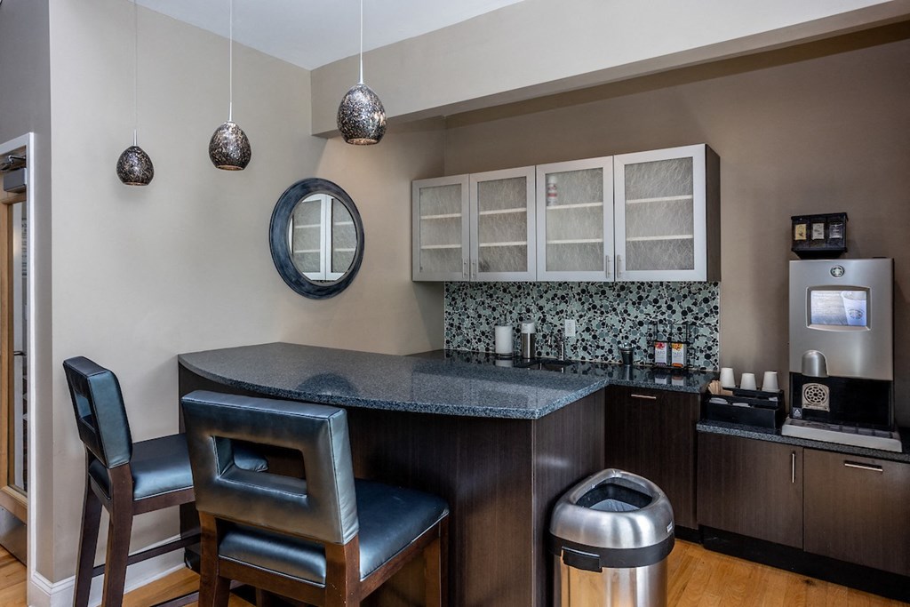 a kitchen with a counter top and two chairs