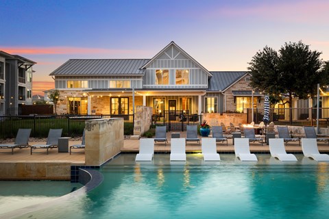 A large house with a pool in front of it.