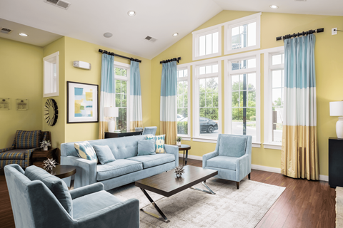 A living room with a blue couch and a coffee table.