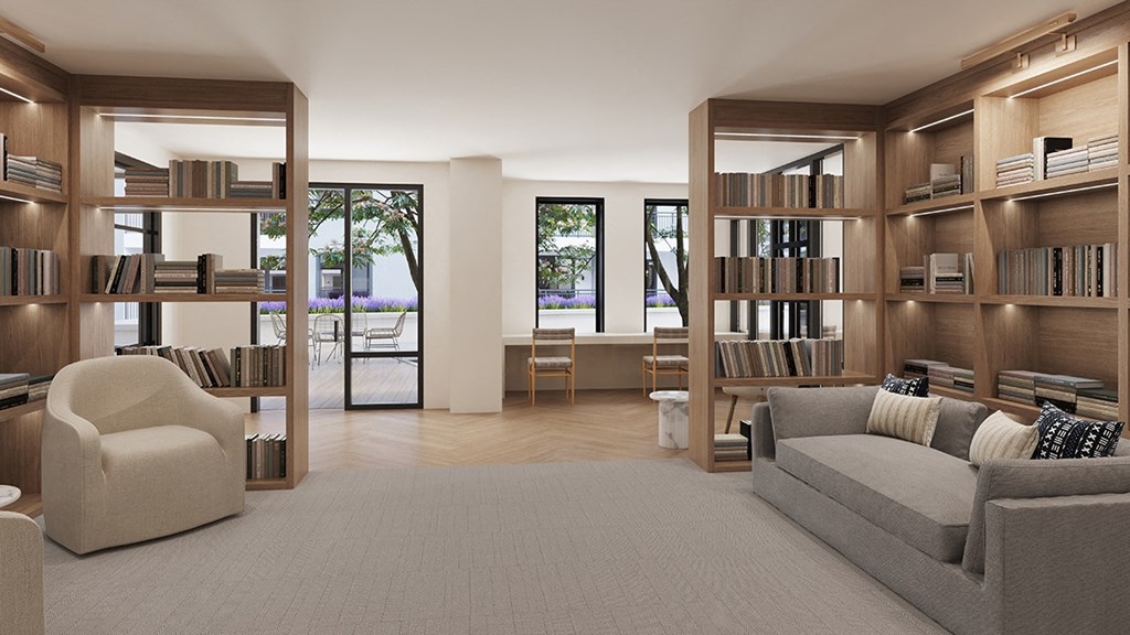 a living room with a couch and chairs and bookshelves
