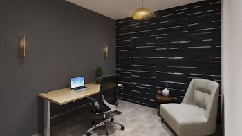 a desk with a laptop and a chair in a room