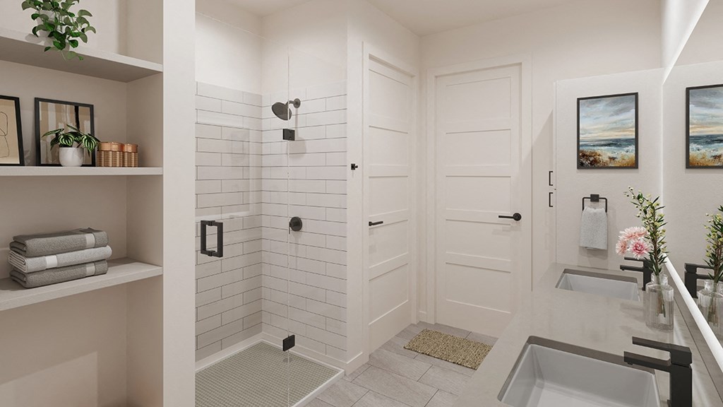 a white bathroom with a shower and a sink