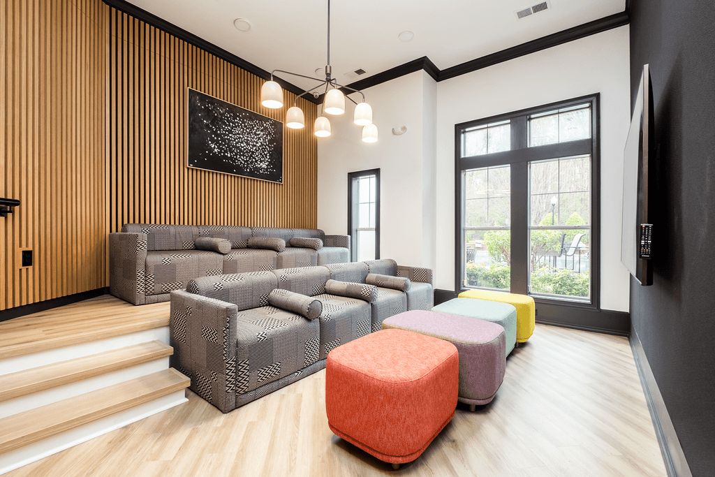 a living room with couches and chairs and a large window