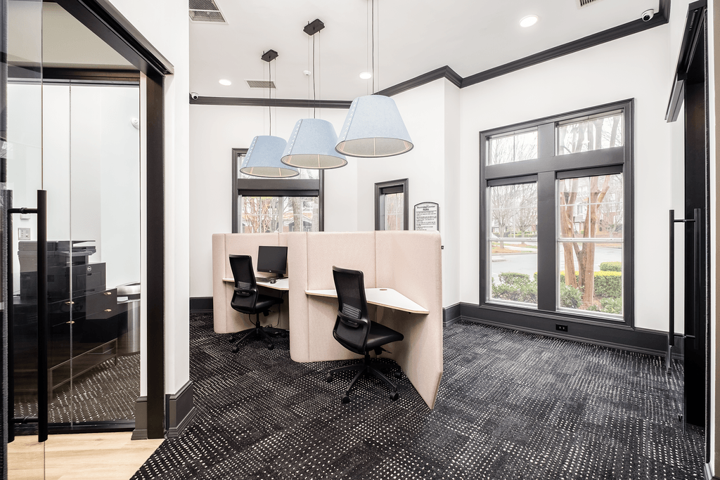 a conference room with a table and chairs and a large window