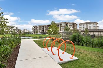a park with orange sculptures in front of an apartment building